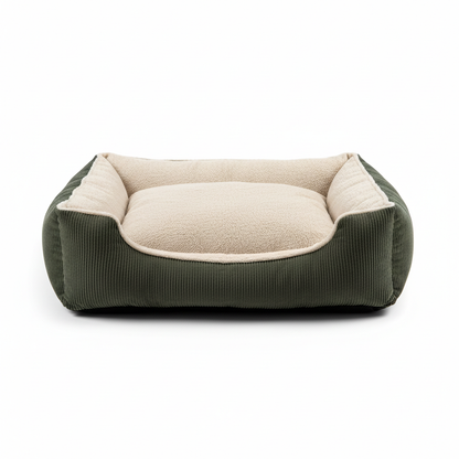 Luxury bolster dog bed with corduroy sides and plush beige interior on white background